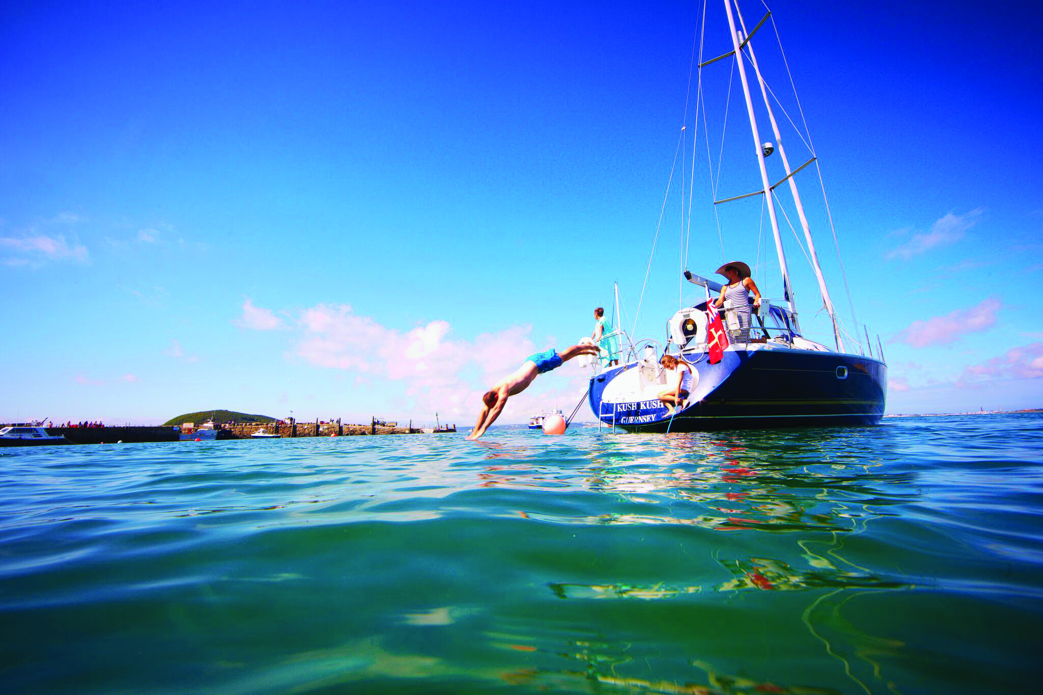 Herm Harbour. Man Diving from Boat